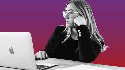 A woman stares at her laptop looking bored