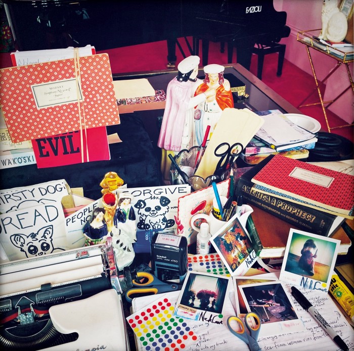 Cave’s desk, with Polaroids, £100 each, and?Dread tiles, £20 each