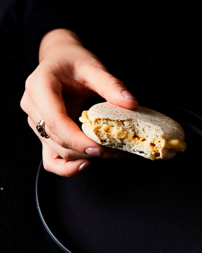 A woman’s hand holding Coda’s ice-cream sandwich desert