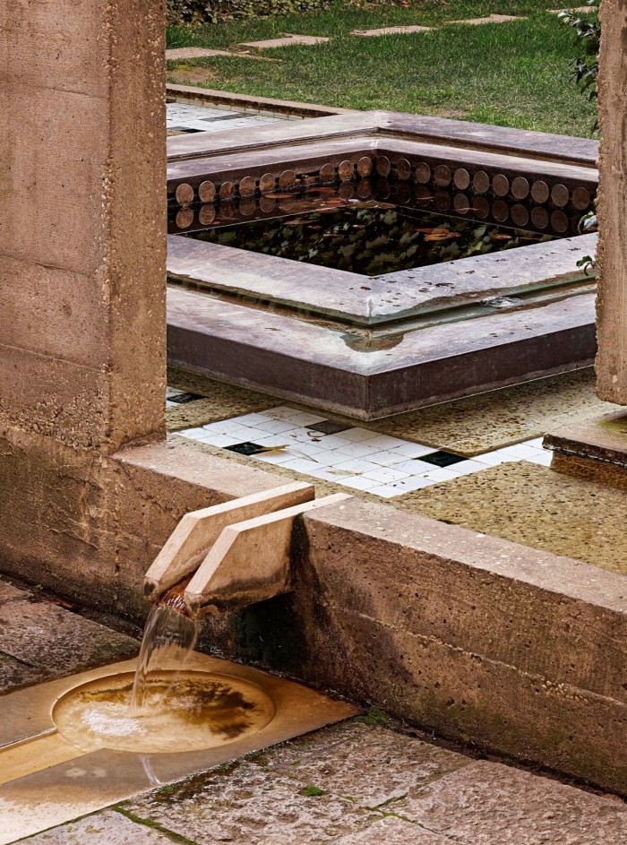 A small stone water feature running into a bronze basin in the Fondazione Querini Stampalia’s garden