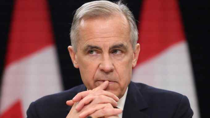 Canada’s Prime Minister Mark Carney listens at a press conference